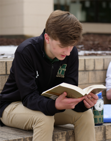 Boy studying outside